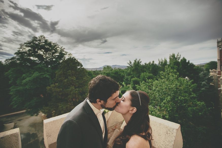 Bride and Groom Kiss on Balcony